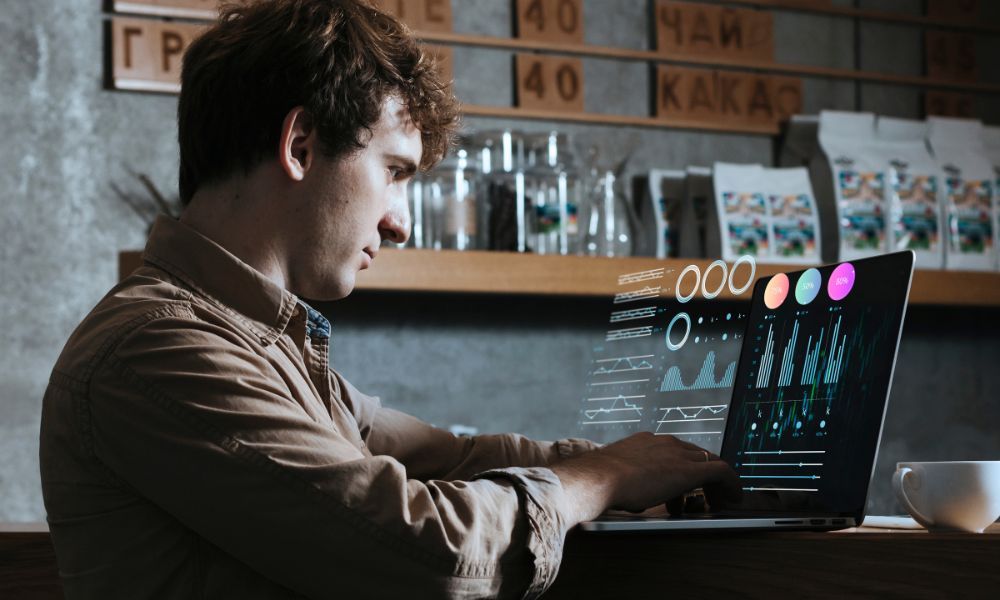 Person working on a laptop with floating data dashboard graphics showing analytics charts, percentage indicators, and performance metrics